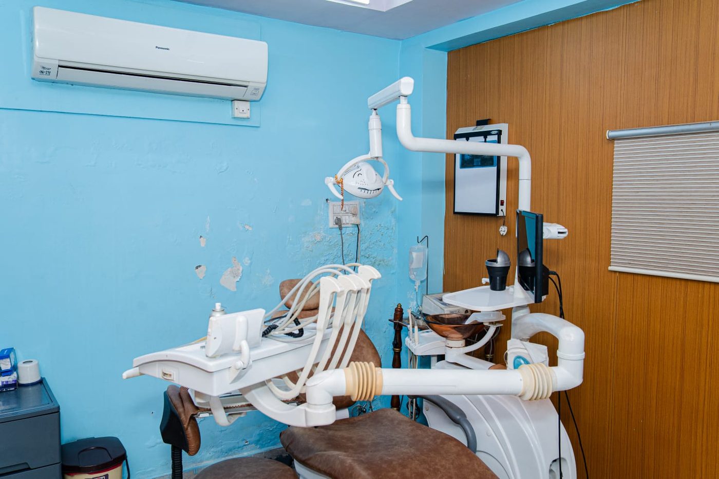 A treatment room at Pain-Off Dental Care with the dental chair, overhead light and instrument tray